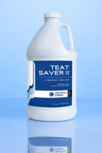 Plastic gallon jug of Teat Saver II teat dip from Crystal Creek, used before and after milking to protect cow udders from infection.