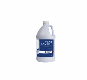 Plastic gallon jug of Teat Saver II teat dip from Crystal Creek, used before and after milking to protect cow udders from infection.